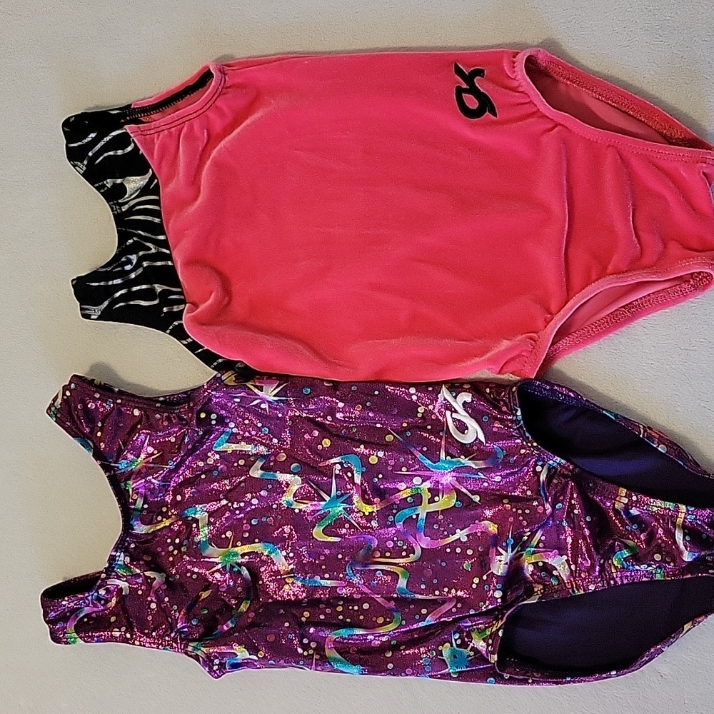 2 girls GK elite gymnastics leotards